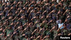 Member of the Kenya Defence Force (KDF) salute during a military honours and memorial service of Kenya's military chief, General Francis Ogolla who was killed in a military helicopter crash, the Ulinzi Sports Complex in Langata district of Nairobi, Kenya April 20, 2024.