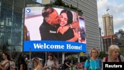 FILE - A screen displays a picture of Noa Argamani who was kidnapped during the deadly October 7 attack and, according to the military, rescued by the Israeli forces, in Tel Aviv, Israel, June 10, 2024.