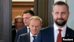 Donald Tusk, leader of Civic Platform (PO), Wladyslaw Kosiniak-Kamysz and Szymon Holownia from Third Way and Wlodzimierz Czarzasty from New Left party arrive for a statement before their meetings with the Polish president, Oct. 24, 2023.