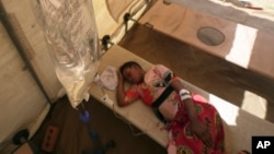 FILE - A cholera patient lies on a hospital bed in Harare, Zimbabwe, Nov. 19, 2023. The number of cholera deaths reported last year worldwide ballooned from the previous year by 71%, the World Health Organization reported Wednesday.   