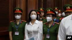 FILE - Vietnamese real estate tycoon Truong My Lan, front center, is escorted into a courtroom in Ho Chi Minh City, Vietnam, March 5, 2024.