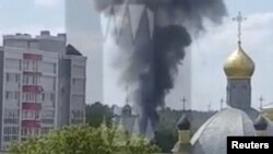 Smoke rises on the site of a helicopter crash in the town of Klintsy in the Bryansk Region, Russia, in this still image taken from video released May 13, 2023. (Ostorozhno Novosti/Handout via Reuters)