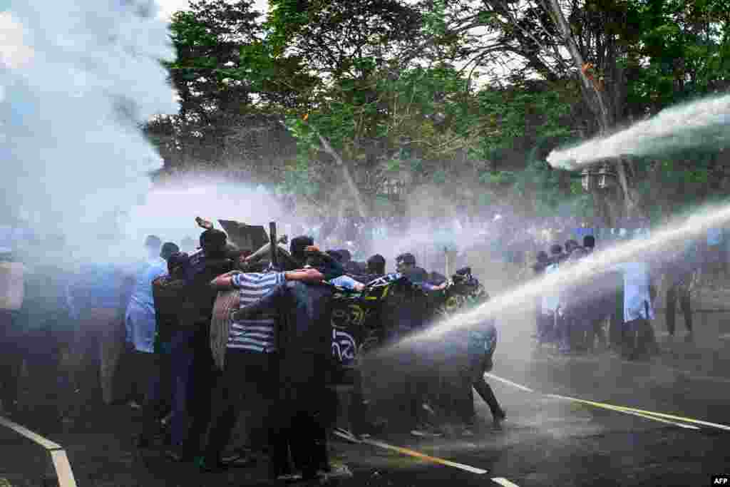 Police use water cannons to disperse university students demanding the closing of private medical universities during an anti-government demonstration in Colombo, Sri Lanka.