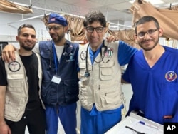 Dr. Ammar Ghanem of Detroit, volunteering with the Syrian American Medical Society, second from right, is pictured May 7, 2024, in Khan Younis, Gaza, with other doctors at the European General Hospital, where they had been since early May.