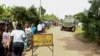 Locals gather at the cordoned scene outside the Mpondwe Lhubirira Secondary School, after militants linked to rebel group Allied Democratic Forces (ADF) killed and abducted multiple people, in Mpondwe, western Uganda, June 17, 2023. 