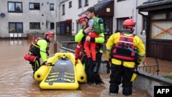 Rescue workers evacuate a family trapped at home in a flooded street in Brechin, northeast Scotland, on Oct. 20, 2023, as Storm Babet batters the country.