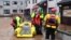 Rescue workers evacuate a family trapped at home in a flooded street in Brechin, northeast Scotland, on Oct. 20, 2023, as Storm Babet batters the country.