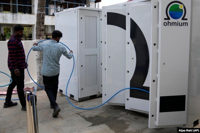 Technicians conduct tests on the electrolyzer hydrogen module at the Ohmium manufacturing facility in Chikkaballapur, outside Bengaluru, India, Tuesday, April 25, 2023. (AP Photo/Aijaz Rahi)