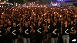 A torchlight procession moves through Yerevan, Armenia, April 23, 2023, to commemorate the estimated 1.5 million Armenians killed by Ottoman Turks more than a century ago.