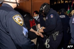 Polisi New York (NYPD) menahan mahasiswa dan para pengunjuk rasa pro-Palestina yang mendirikan perkemahan di kampus Universitas New York (NYU) untuk memprotes perang Israel-Hamas, di New York, 22 April 2024. (Alex Kent / AFP)