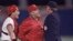 FILE - St. Louis Cardinals manager Whitey Herzog, middle, lets umpire John Shulock, right, know how he feels about Shulock's call during Game 5 of the World Series in St. Louis, Missouri, Oct. 24, 1985. Cardinals catcher Tom Nieto, left, also shares his thoughts.