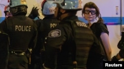 Photojournalist Olga Fedorova is detained by police in the midst of pro-Palestinian protesters trying to march after demonstrating outside the Israeli consulate, on the sidelines of the Democratic National Convention in Chicago, Illinois, Aug. 20, 2024. 