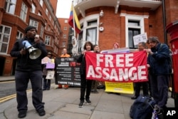 Protesters rally outside the Ecuadorian Embassy in London, April 11, 2024, where Wikileaks founder Julian Assange was arrested five years ago.