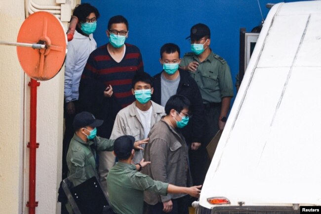 FILE - Pro-democracy activists Sam Cheung, Lam Cheuk-ting, Raymond Chan Chi-chuen and Owen Chow walk to a prison van to head to court, over national security law charges, in Hong Kong, China March 2, 2021. (REUTERS/Tyrone Siu/File Photo)