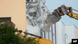 Crews start the demolition of the Marjory Stoneman Douglas High School building, Friday, June 14, 2024, where 17 people died in the 2018 mass shooting in Parkland, Fla. (AP Photo/Wilfredo Lee)