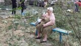 A resident sits near her residential building damaged by a Russian missile strike in Mykolaiv, Ukraine, July 19, 2024. Russian drones and missiles struck Ukraine overnight, killing two and hitting energy facilities and railway infrastructure across the country, said officials. 