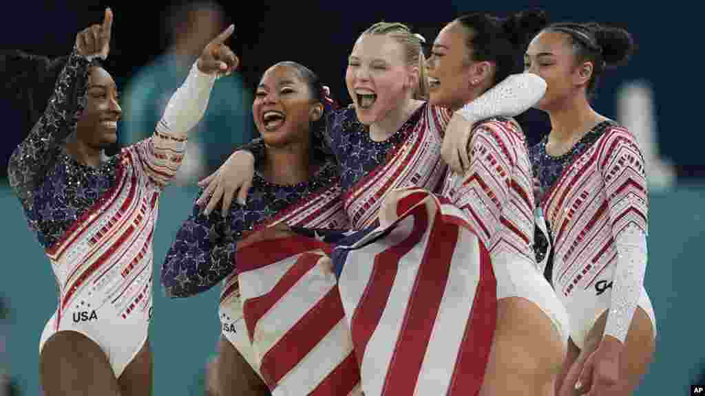 Members of Team USA celebrate after winning the gold medal during the women's artistic gymnastics team finals round at Bercy Arena at the 2024 Summer Olympics, July 30, 2024, in Paris, France.