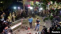 Forensic officials examine the spot where Atiq Ahmed, a former lawmaker in India's parliament, accused in several criminal cases, and his brother Ashraf Ahmed were shot dead in Prayagraj, India, Apr. 15, 2023.