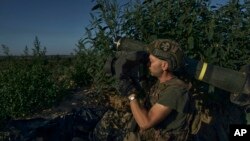 A Ukrainian serviceman prepares an anti-tank rocket launcher aiming towards Russian positions at the front line close to Donetsk, Ukraine, Aug. 19, 2023. 