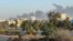 Smoke rises amid clashes between armed factions, in Tripoli, Libya, Aug. 15, 2023.