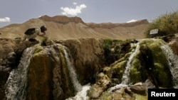 FILE - An Afghan man performs ablution before prayers at Band-E-amir in Bamiyan, Afghanistan, Aug. 31, 2005. Unknown gunmen killed four people May 17, 2024, in Bamiyan's central market, Taliban authorities said.