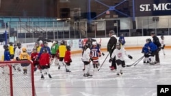 FILE - Players from around North America take part in the NHL All-Star Youth Hockey Jamboree Celebration at St. Michael's College School Arena in York, Ontario, Feb. 3, 2024, during All-Star Weekend in Toronto, Canada.