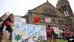 FILE - West Virginia University students lead a protest against cuts to programs in world languages, creative writing and more amid a $45 million budget deficit, Aug. 21, 2023, outside Stewart Hall in Morgantown, W.Va. 