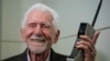 Martin Cooper, the inventor of first commercial mobile phone, poses with a Motorola DynaTAC 8000x during an interview with The Associated Press at the Mobile World Congress 2023 in Barcelona, Spain, Feb. 27, 2023.