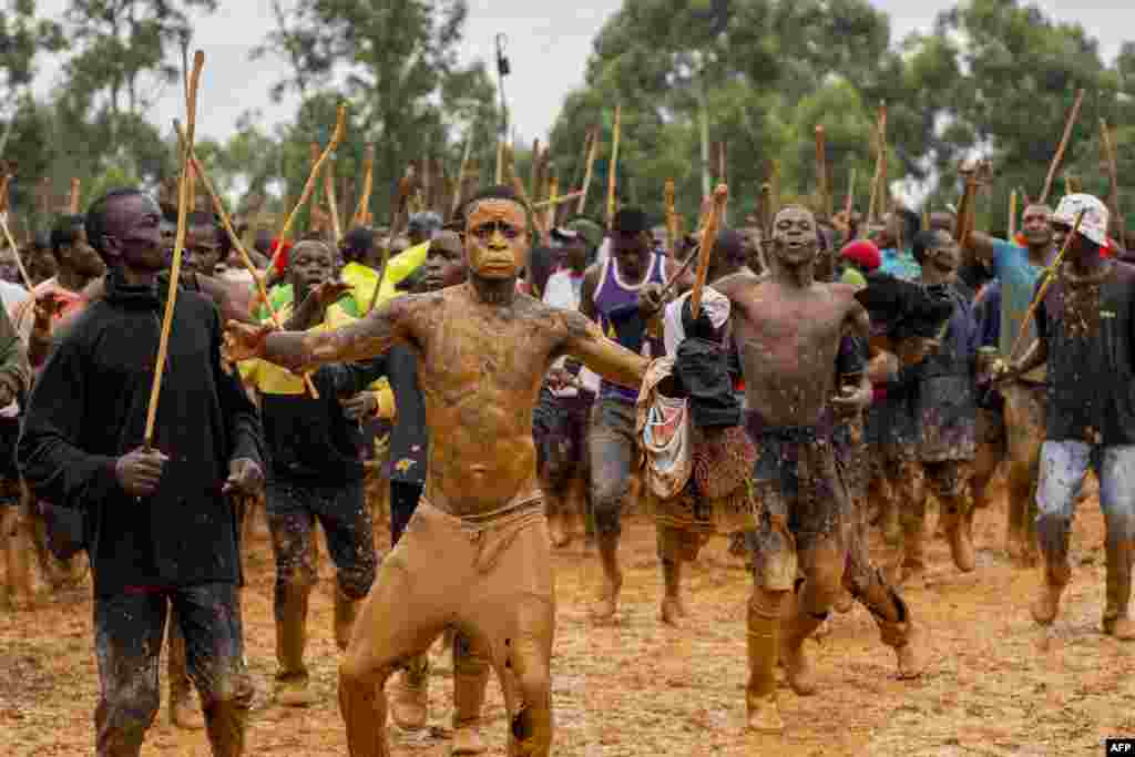 Supporters dance and chant in between matches during a traditional bullfighting tournament in Malinya Stadium, near Kakamega, Kenya.