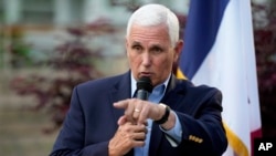 FILE - Former Vice President Mike Pence speaks to local residents on May 23, 2023, in Des Moines, Iowa. The Department of Justice said it won't  pursue criminal charges related to the discovery of classified documents at his Indiana home. 