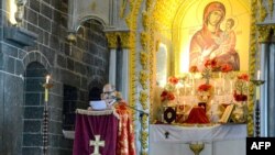 A priest celebrates the Easter mass at the Armenian church Surp Giragos, in Diyarbakir, southeastern Turkey, on April 9, 2023.