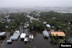 A drone view shows houses and streets flooded as Hurricane Debby affects the gulf coast in Suwannee, Florida, Aug. 5, 2024.