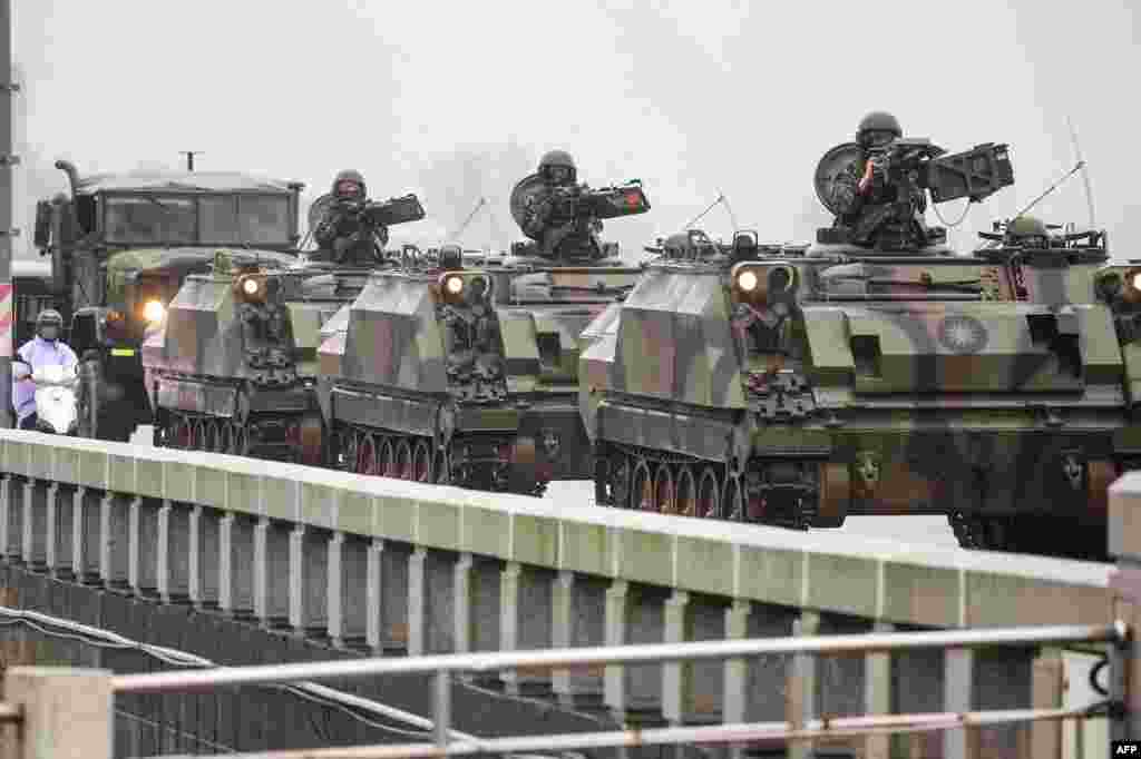 Taiwanese armored vehicles roll down a street in Kinmen. China warned on Friday that Taiwan&#39;s leadership was pushing the self-ruled island into &quot;a perilous situation of war and danger&quot; and that it would go &quot;further&quot; if provoked, as Beijing conducted military drills around the territory.