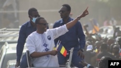 Success Masra, center, gestures as he arrives for a meeting of the Chadian political party Succes Masra (C) gestures as he arrives for a meeting of the Chadian political party The Transformers, in NDjamena on March 10, 2024.