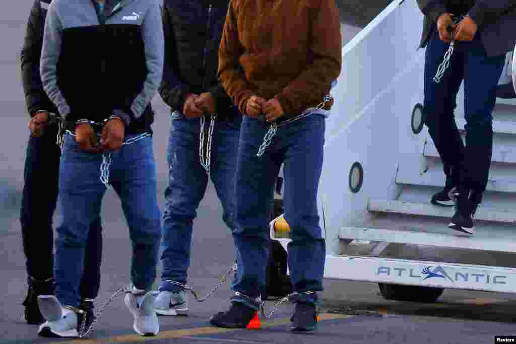 Migrants who were moved from Plattsburgh, New York to El Paso, Texas, get off a plane at the airport in El Paso, March 21, 2023.