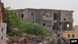 FILE - War-damaged buildings are pictured in a Tripoli suburb on May 28, 2024. Libya, a major oil producer on the Mediterranean, has had little stability since a 2011 NATO-backed uprising.