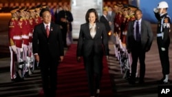 U.S. Vice President Kamala Harris, center, walks with Indonesian Health Minister Budi Gunadi Sadikin upon her arrival to attend the ASEAN Summit, at Soekarno-Hatta International Airport in Tangerang, near Jakarta, Indonesia, Sept. 5, 2023.