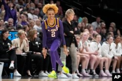 LSU's Jasmine Carson reacts to her three-pointer during the first half of the NCAA Women's Final Four championship basketball game against Iowa, April 2, 2023, in Dallas.