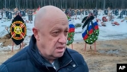 FILE - Wagner Group head Yevgeny Prigozhin attends the funeral of Dmitry Menshikov, a Wagner group fighter who died in Ukraine, at the Beloostrovskoye cemetery outside St. Petersburg, Russia, on Dec. 24, 2022.