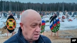 资料照片: 2022年12月24日，瓦格纳集团首领叶夫根尼·普里戈津在俄罗斯圣彼得堡郊外的别洛斯特罗夫斯科耶公墓参加了在乌克兰阵亡的瓦格纳集团战士德米特里·缅什科夫的葬礼。