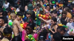 Locals and tourists play with water as they celebrate the Songkran holiday which marks the Thai New Year in Bangkok, Thailand, April 13, 2023. REUTERS/Chalinee Thirasupa