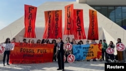 Climate activists protest after a draft of a negotiation deal was released, at the United Nations Climate Change Conference COP28 in Dubai, United Arab Emirates, Dec. 13, 2023.