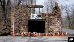 Cones cordon off fallen debris from the historic Taylor's Mill in Lebanon, N.J., Friday, April 5, 2024.