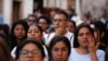 A woman wipes away tears during a demonstration protesting the kidnapping and killing of an 8-year-old girl, in the main square of Taxco, Mexico, March 28, 2024. 