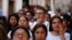 A woman wipes away tears during a demonstration protesting the kidnapping and killing of an 8-year-old girl, in the main square of Taxco, Mexico, March 28, 2024. 