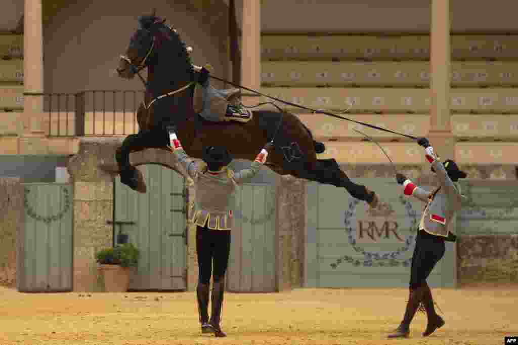 Horsemen take part in an equestrian show marking the 450th anniversary of the Real Maestranza de Caballeria cultural institution in Ronda, Spain. 