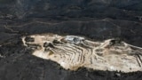 A drone view shows a charred forest area around a marble quarry following a wildfire, in Dionysos, near Athens, Greece.