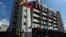 FILE - A member of the National Guard walks past the Supreme Justice Tribunal building in Caracas, Jan. 29, 2019.