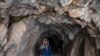 FILE - A Taliban fighter walks at an archaeological site in Mes Aynak, in the eastern province of Logar, May 17, 2022. Mes Aynak — believed to be between 1,000 and 2,000 years old — was once a vast city organized around the extraction and trade of copper.