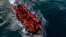 FILE - In this drone view an inflatable dinghy carrying migrants makes its way towards England in the English Channel, Britain, May 4, 2024. 